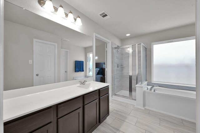 2233 Forest Chestnut Dr, Spring, TX 77386 - ensuite bathroom featuring a shower stall, a garden tub, and vanity