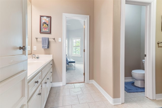 208 Canyon Oak Dr, Lake Jackson, TX 77566 - bathroom with vanity, tile patterned flooring, toilet, and baseboards