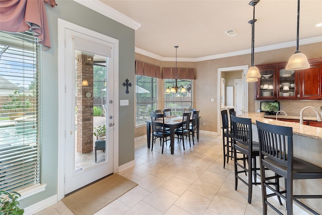208 Canyon Oak Dr, Lake Jackson, TX 77566 - kitchen with light tile patterned floors, backsplash, baseboards, light stone counters, and crown molding