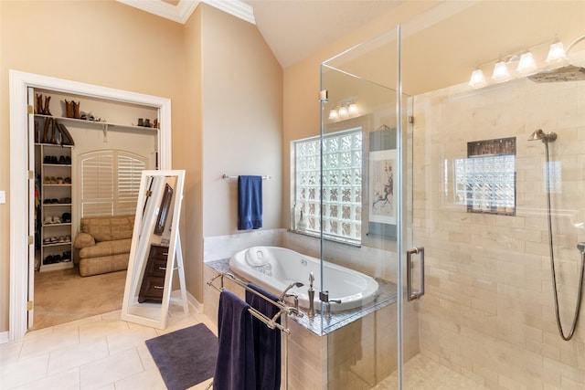 208 Canyon Oak Dr, Lake Jackson, TX 77566 - full bathroom with a shower stall, tile patterned floors, vaulted ceiling, a bath, and ornamental molding