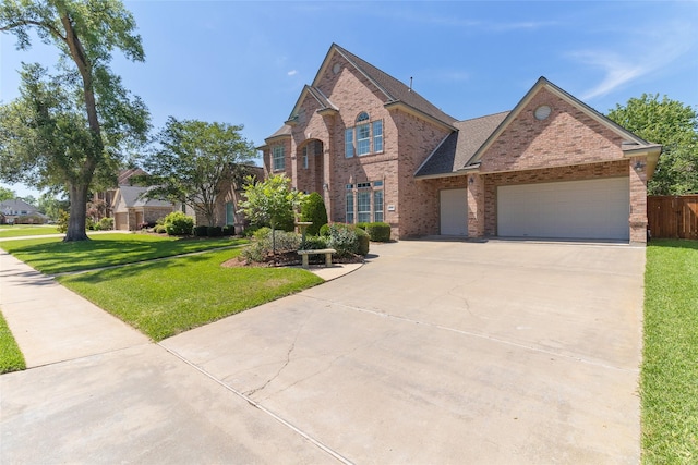 208 Canyon Oak Dr, Lake Jackson, TX 77566 - view of front of house featuring brick siding, driveway, and a garage