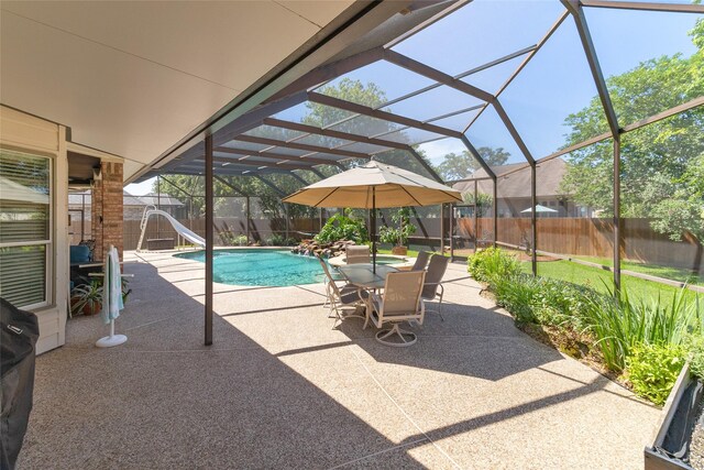 208 Canyon Oak Dr, Lake Jackson, TX 77566 - view of swimming pool featuring a patio area, a fenced backyard, a water slide, and a lanai