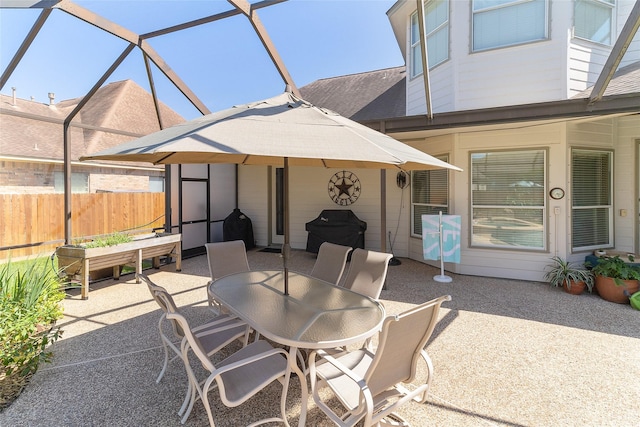 208 Canyon Oak Dr, Lake Jackson, TX 77566 - view of patio / terrace featuring outdoor dining space, fence, and glass enclosure