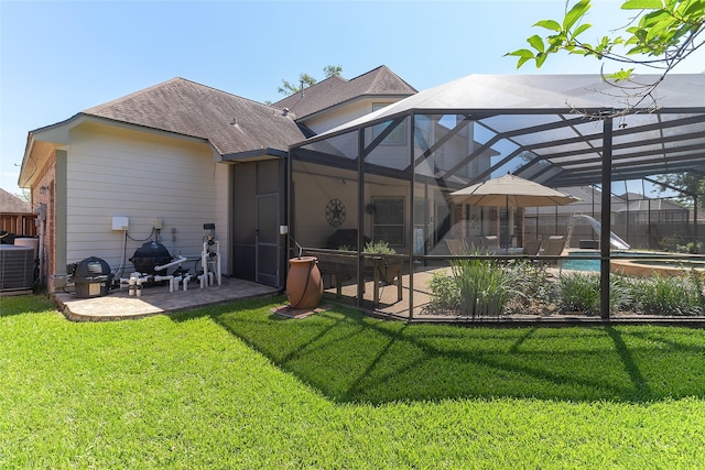 208 Canyon Oak Dr, Lake Jackson, TX 77566 - back of property with a patio, central AC, a yard, and a lanai