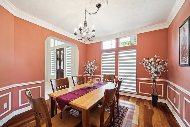 7719 Allegro Dr, Houston, TX 77040 - dining space featuring arched walkways, a chandelier, ornamental molding, and dark wood-type flooring