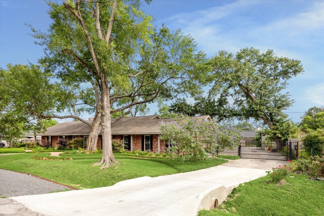 1415 Lehman St, Houston, TX 77018 - view of front of house with driveway, a gate, and brick siding