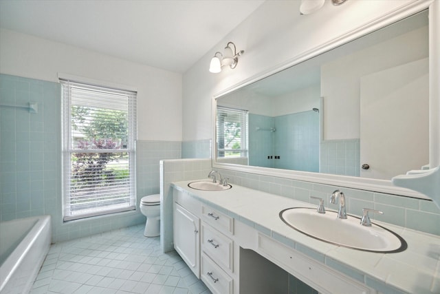 1415 Lehman St, Houston, TX 77018 - bathroom featuring tile walls, tile patterned floors, a shower, toilet, and double vanity