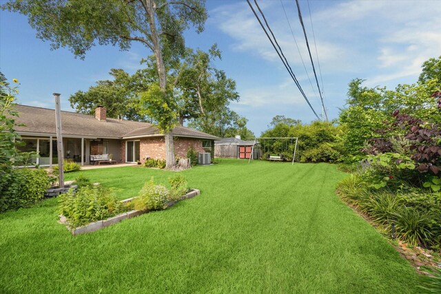 1415 Lehman St, Houston, TX 77018 - view of green lawn featuring central AC, a patio area, an outbuilding, and a storage unit