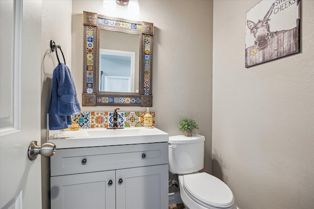 802 Fairway Dr, La Porte, TX 77571 - bathroom featuring vanity, toilet, and a textured wall