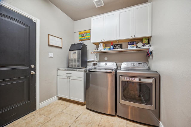 802 Fairway Dr, La Porte, TX 77571 - washroom featuring independent washer and dryer, cabinet space, light tile patterned floors, and baseboards