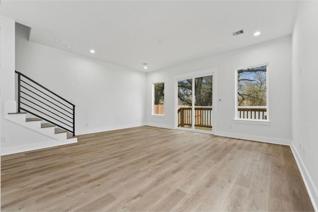 5518 Cortlandt St Unit A, Houston, TX 77076 - unfurnished living room featuring light wood-type flooring, stairs, baseboards, and recessed lighting