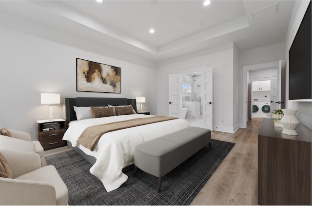 5518 Cortlandt St Unit A, Houston, TX 77076 - bedroom with washer and dryer, light wood-type flooring, a tray ceiling, recessed lighting, and baseboards