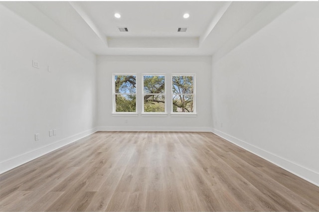 5518 Cortlandt St Unit A, Houston, TX 77076 - unfurnished room featuring a raised ceiling, baseboards, light wood finished floors, and recessed lighting