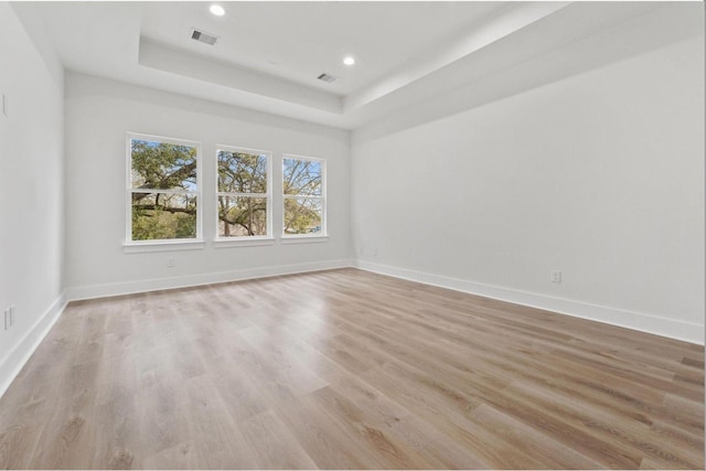 5518 Cortlandt St Unit A, Houston, TX 77076 - spare room featuring a raised ceiling, baseboards, light wood-style flooring, and recessed lighting