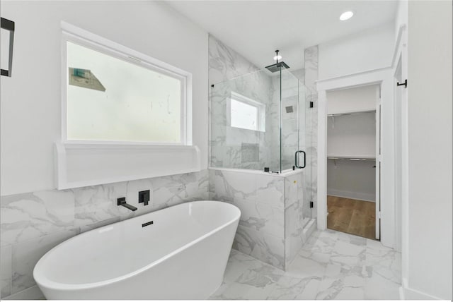 5518 Cortlandt St Unit A, Houston, TX 77076 - full bath with a marble finish shower, a freestanding bath, marble finish flooring, tile walls, and a walk in closet