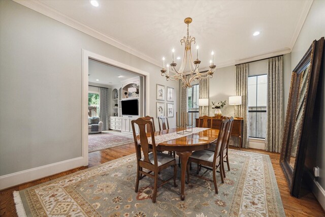 4504 Birch St, Bellaire, TX 77401 - dining space with a chandelier, crown molding, wood finished floors, baseboards, and recessed lighting