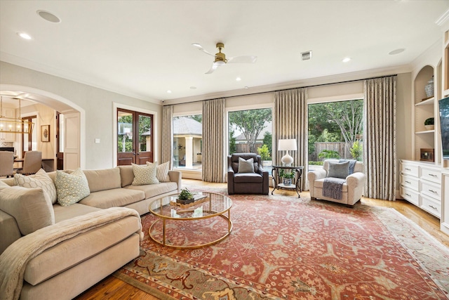 4504 Birch St, Bellaire, TX 77401 - living area featuring ornamental molding, wood finished floors, arched walkways, a ceiling fan, and recessed lighting
