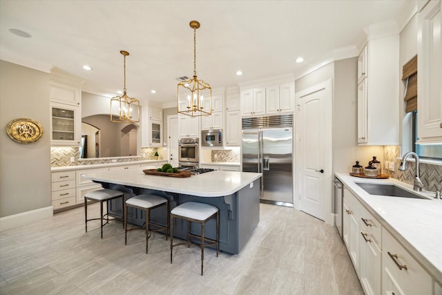 4504 Birch St, Bellaire, TX 77401 - kitchen with built in appliances, a sink, tasteful backsplash, recessed lighting, and ornamental molding
