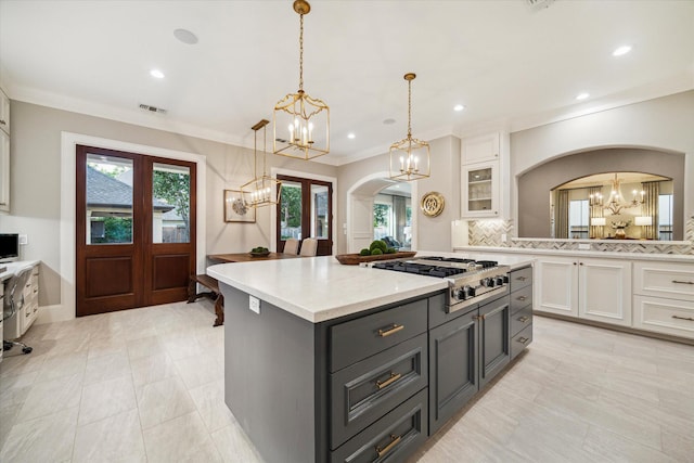 4504 Birch St, Bellaire, TX 77401 - kitchen with a chandelier, arched walkways, white cabinetry, plenty of natural light, and ornamental molding