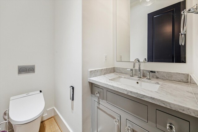 5211 Calle Cordoba Pl, Houston, TX 77007 - bathroom with baseboards, toilet, and vanity