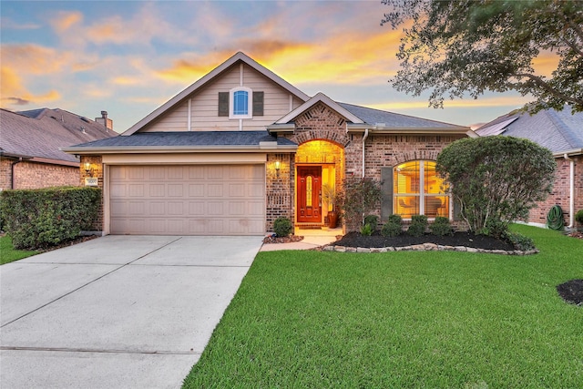 traditional-style house featuring brick siding, a front lawn, concrete driveway, and a garage