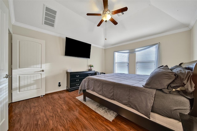 bedroom featuring dark wood-type flooring, vaulted ceiling, ceiling fan, baseboards, and crown molding