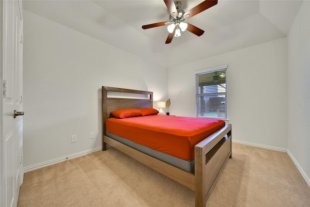 bedroom with light colored carpet, baseboards, and ceiling fan