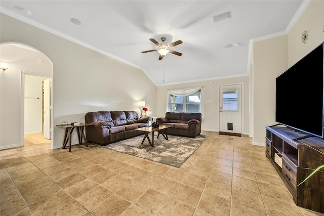 living room featuring a ceiling fan, crown molding, baseboards, arched walkways, and vaulted ceiling