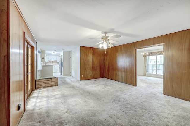 9603 Emnora Ln, Houston, TX 77080 - spare room with wood walls, a ceiling fan, light carpet, and a chandelier