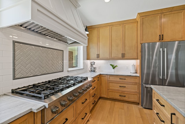13911 Falcon Heights Dr, Cypress, TX 77429 - kitchen with appliances with stainless steel finishes, custom exhaust hood, decorative backsplash, and light wood-style floors
