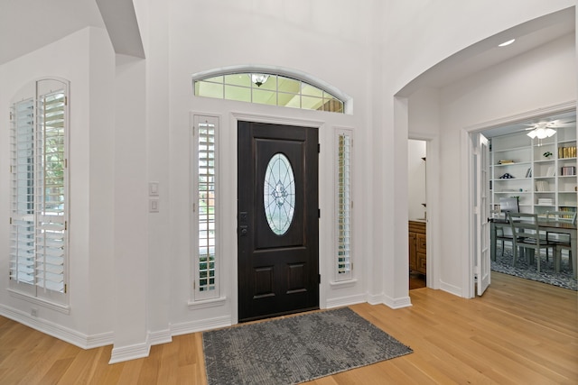 13911 Falcon Heights Dr, Cypress, TX 77429 - entryway with arched walkways, light wood-style floors, and baseboards