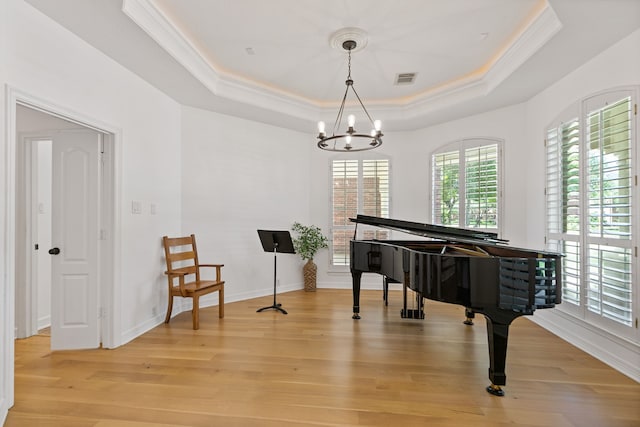13911 Falcon Heights Dr, Cypress, TX 77429 - sitting room with a tray ceiling, ornamental molding, light wood-style flooring, a chandelier, and baseboards