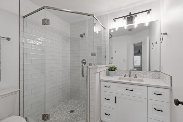 13911 Falcon Heights Dr, Cypress, TX 77429 - full bathroom featuring a stall shower, toilet, backsplash, and vanity