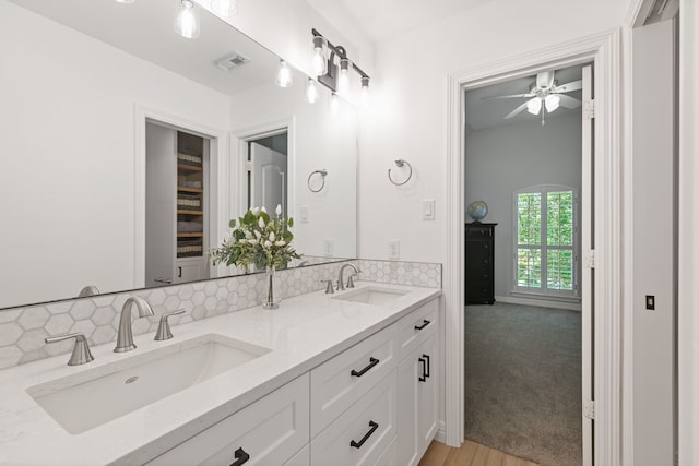 13911 Falcon Heights Dr, Cypress, TX 77429 - bathroom with backsplash, a ceiling fan, double vanity, and wood finished floors