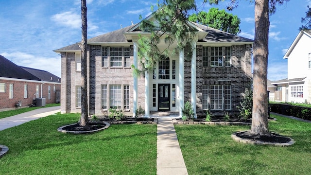 22611 Bucktrout Ln, Katy, TX 77449 - view of front of property featuring brick siding, a front yard, and central AC