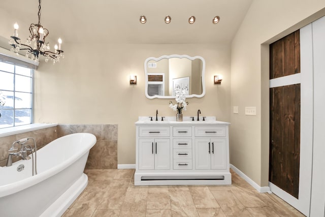 22611 Bucktrout Ln, Katy, TX 77449 - full bathroom featuring a chandelier, a freestanding tub, double vanity, and baseboards