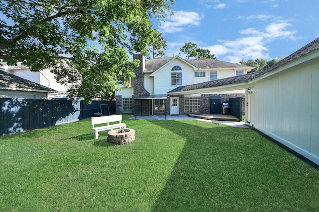 22611 Bucktrout Ln, Katy, TX 77449 - rear view of house with an outdoor fire pit, a patio, and a chimney