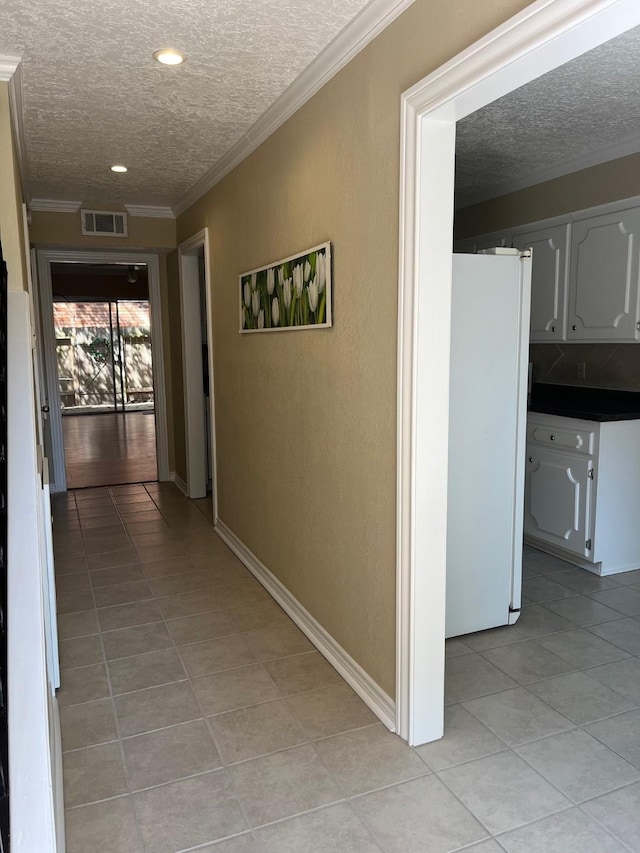 5207 Arboles Dr Unit 3, Houston, TX 77035 - hallway with a textured ceiling, light tile patterned flooring, ornamental molding, recessed lighting, and a textured wall