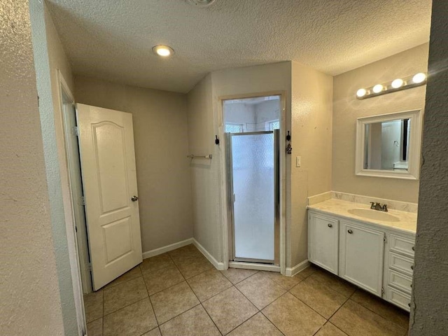 11111 Sagecrest Ln, Houston, TX 77089 - full bathroom with tile patterned floors, a shower stall, vanity, a textured ceiling, and baseboards