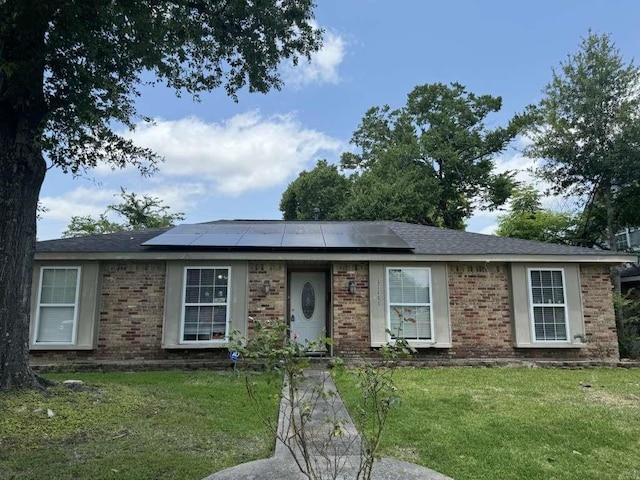 11111 Sagecrest Ln, Houston, TX 77089 - view of front of house with a front lawn, solar panels, and brick siding