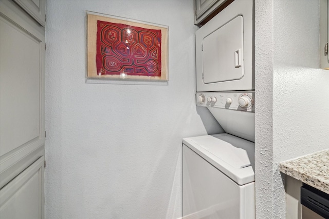 1860 White Oak Dr Unit 246, Houston, TX 77009 - washroom featuring stacked washer and clothes dryer and a textured wall