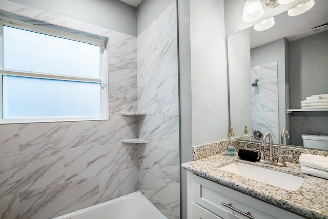 3409 Providence St, Houston, TX 77020 - bathroom featuring vanity, toilet, and washtub / shower combination