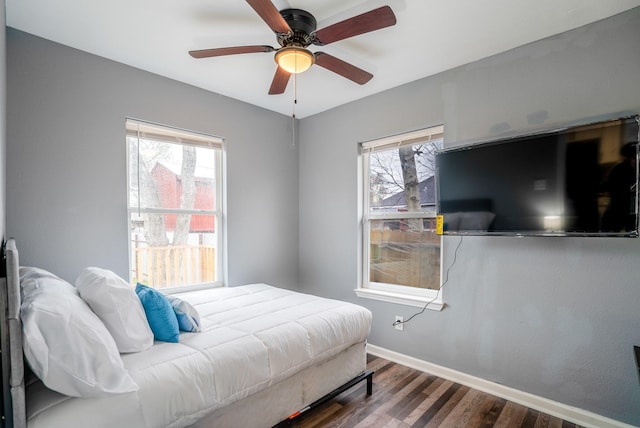 3409 Providence St, Houston, TX 77020 - bedroom featuring dark wood-style flooring, baseboards, and a ceiling fan
