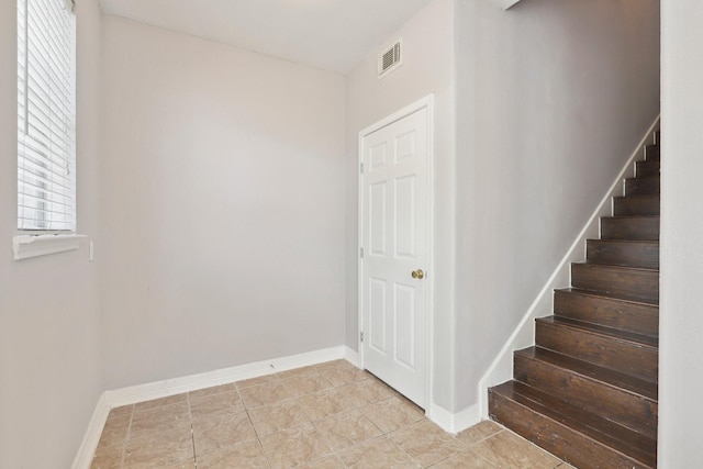 2203 Centerbrook Ln, Katy, TX 77450 - stairway featuring baseboards and tile patterned flooring
