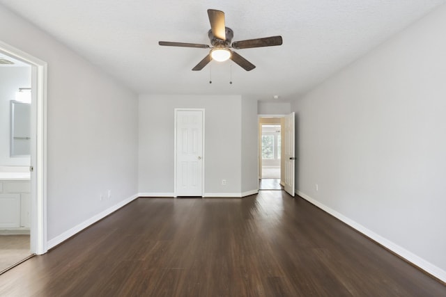 2203 Centerbrook Ln, Katy, TX 77450 - unfurnished bedroom with dark wood-type flooring, baseboards, ensuite bath, and a ceiling fan