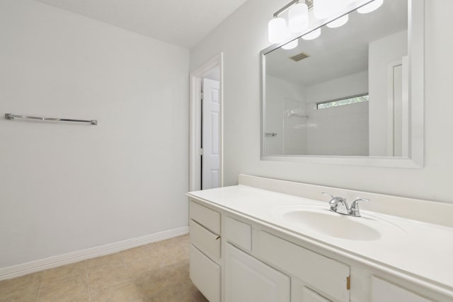 2203 Centerbrook Ln, Katy, TX 77450 - bathroom with a tile shower, vanity, and baseboards