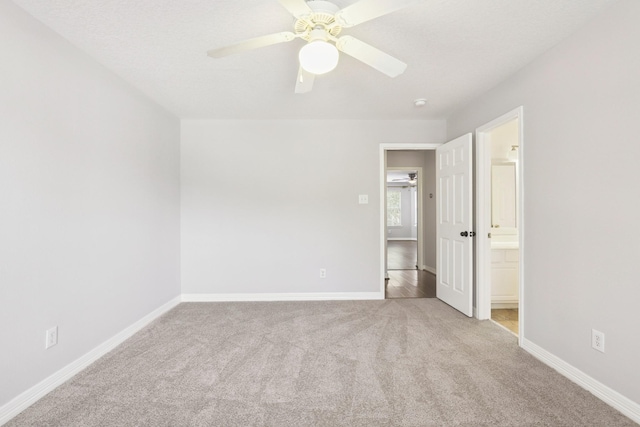 2203 Centerbrook Ln, Katy, TX 77450 - unfurnished bedroom featuring carpet, baseboards, ensuite bathroom, and ceiling fan