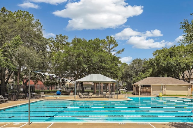 2203 Centerbrook Ln, Katy, TX 77450 - community pool with fence, a patio area, a gazebo, and view of scattered trees