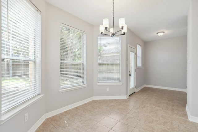 2203 Centerbrook Ln, Katy, TX 77450 - unfurnished dining area with a chandelier, light tile patterned flooring, and baseboards