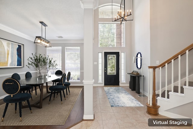 2203 Centerbrook Ln, Katy, TX 77450 - tiled entryway with decorative columns, a chandelier, baseboards, stairs, and ornamental molding